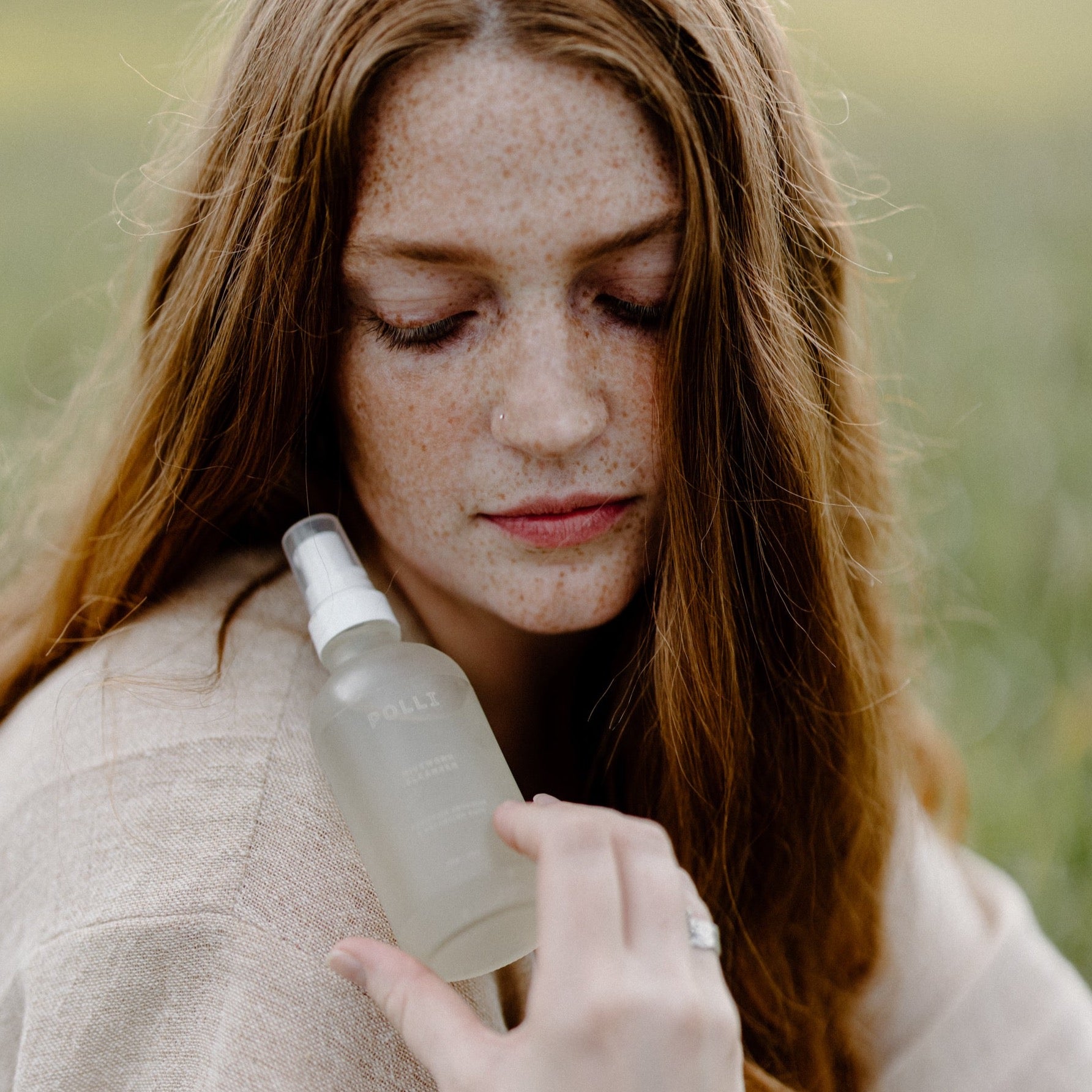 Woman holding bee skincare product.